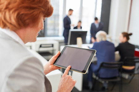 Business woman uses tablet computer as digital tool for communicationの写真素材