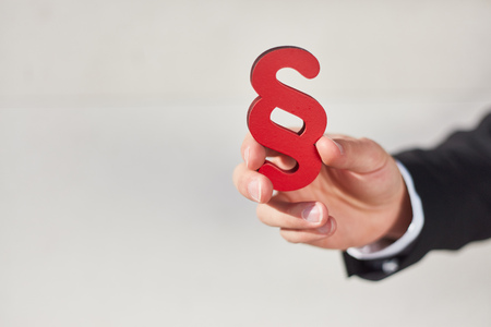 Hand holds a paragraph as a sign of justice and law and lawの写真素材