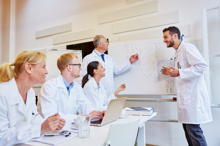 Team of doctors during medical training workshop learning with joyの写真素材
