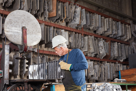 Senior man as foundry worker working with mold at metallurgy factory