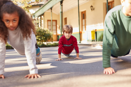 Student group at summer camp doing push-ups as fitness trainingの写真素材