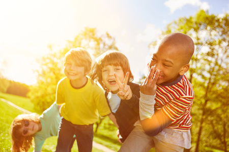 Children have fun together in the summer and show the victory sign by handの写真素材