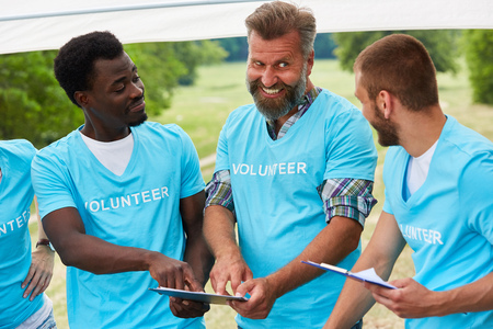 Team volunteer with clipboard at a rescue action meetingの写真素材