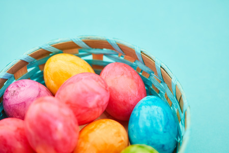 Many colorful easter eggs in the basket as easter decoration