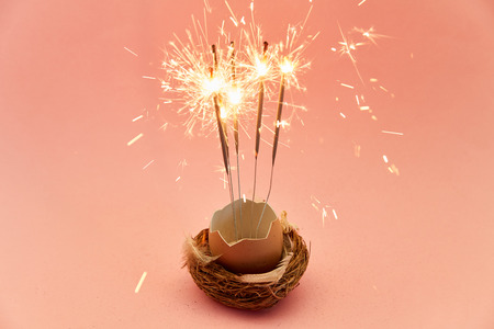 Burning sparklers in an egg as easter decoration