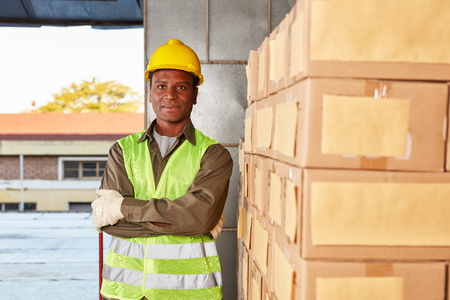 Young worker in training to specialist warehouse in shipping a freight forwarderの写真素材