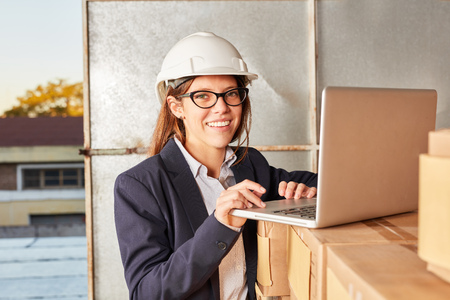 Successful business woman using laptop computer in her logistics start-upの写真素材