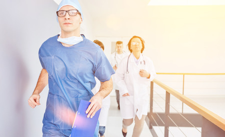 Doctor and team run to emergency in hospitalの写真素材