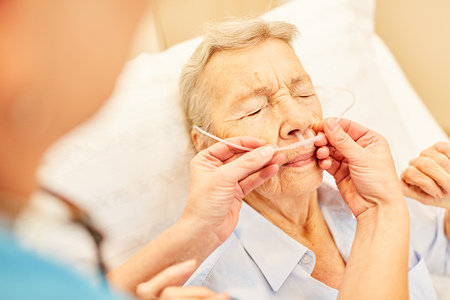 Senior as a patient with nasal cannula during an oxygen therapy in the hospital