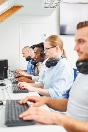 Study colleagues or continuing education workers in a computer course in the officeの写真素材