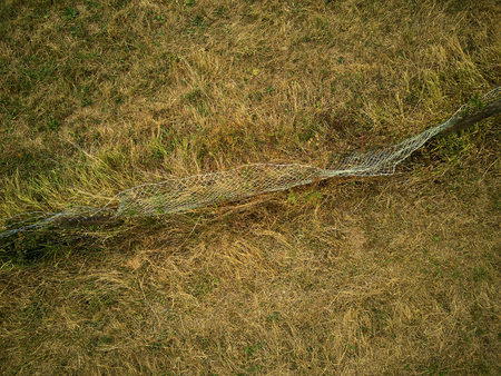 Old chainlink fence on a field from above