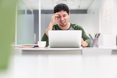 Young man as a programmer or software developer at the computer has an ideaの写真素材