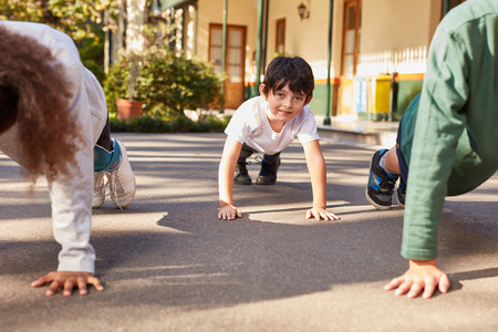 Students in physical education or summer camp train push-upの写真素材