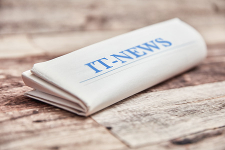 IT News newspaper with technology news on woodの写真素材