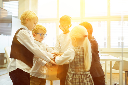Integration through children as a start-up business while hands stack up for motivation