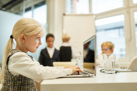 Girl as a businesswoman at the laptop Computer in the office in a meeting