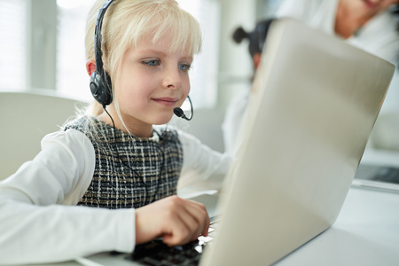 Girl as a student with headset at e-learning or in business call centerの写真素材