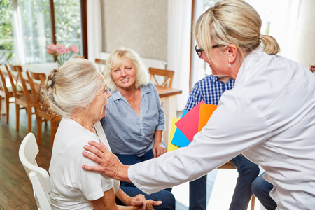 Psychotherapist looks after seniors in a group therapy session