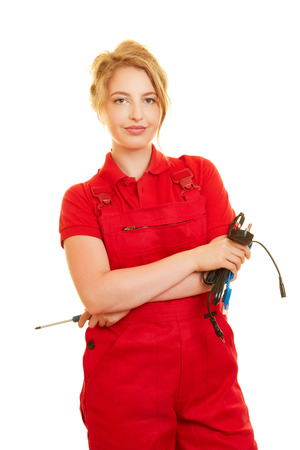 Young blonde woman is training as an electrician or electricianの写真素材