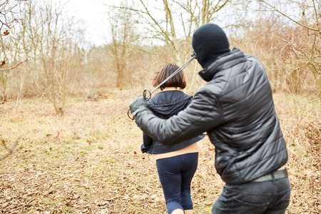 Attacker threatens jogger with robbery in the forest with a nooseの写真素材