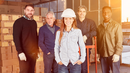Woman is training as a warehouse worker in forwarding in front of a teamの写真素材