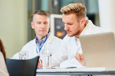 Young doctor in a workshop for training together with an older colleagueの写真素材