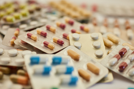 Pile of colorful medicines and pills in blister packagingの写真素材