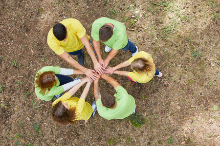 Young people stand in a circle and stack hands for team development and team buildingの写真素材