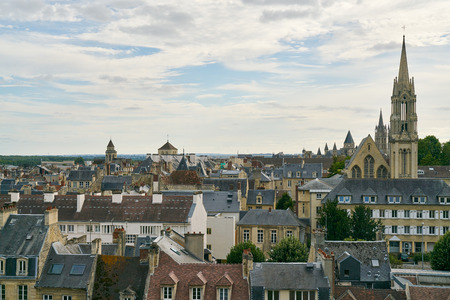City skyline Caen in France with view over rooftops and church towersの写真素材