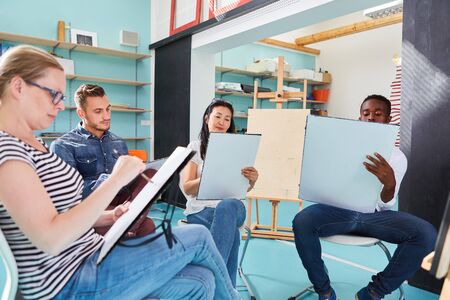 Young people as art students or beginners in the painting class in the community collegeの写真素材