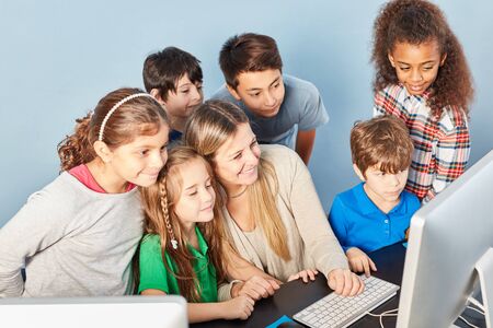 Group of pupils in e-learning in the computer science course of elementary schoolの写真素材