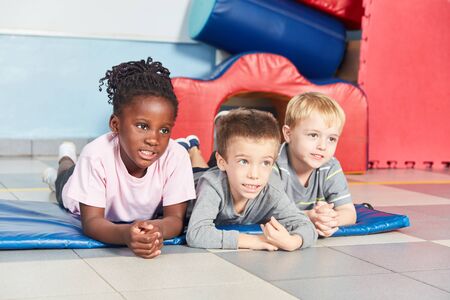 Multicultural children as friends in the gym in kindergarten or preschool