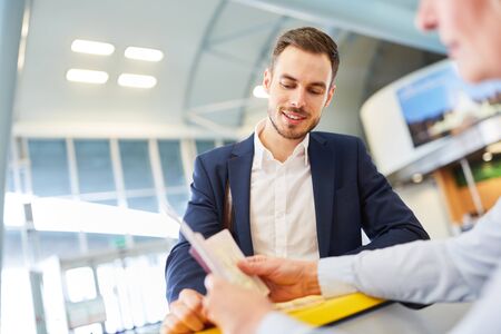 Business man as a passenger at the check in counter at passport control at the airport
