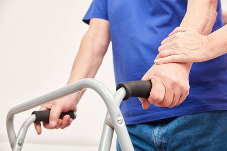 Disabled senior with walker in physiotherapy or occupational therapy