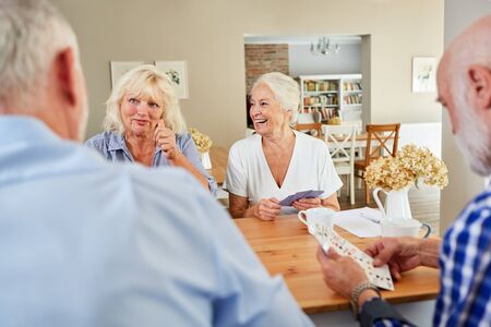 Retired seniors enjoy playing cards in the retirement home