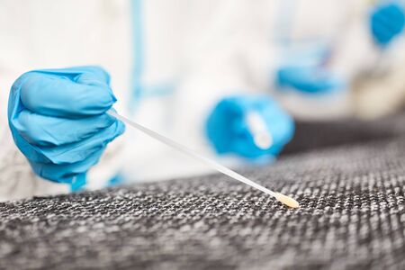 Recording of DNA sample at crime scene by forensic policeの写真素材