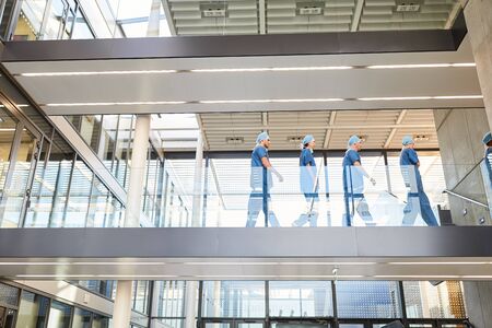 Group of surgeons in the stairway of the clinic on the way to surgery