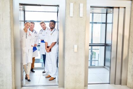Group of doctors stands in the elevator in the hospitalの写真素材