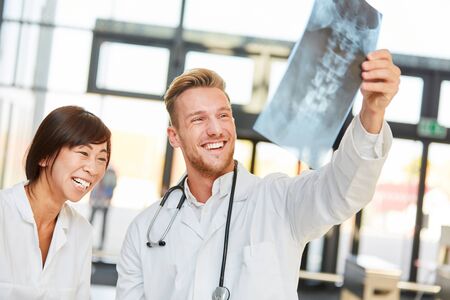 Young doctors look forward to a positive result on an x-rayの写真素材