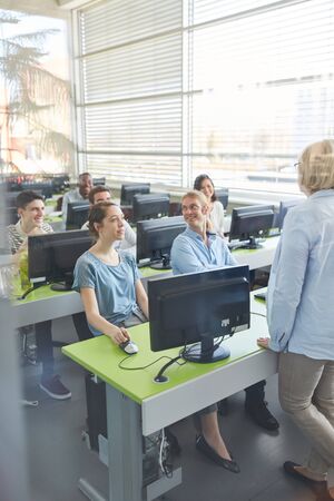 Students learn in computer course at university or college