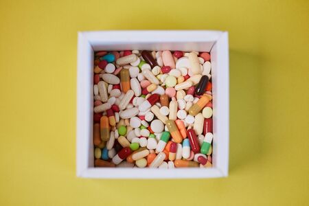 Medicine box with many colorful medications from above