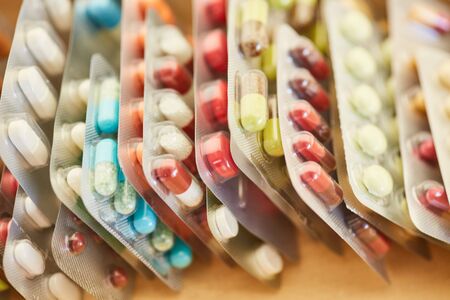 Many colorful medicines in blister packaging in a rowの写真素材