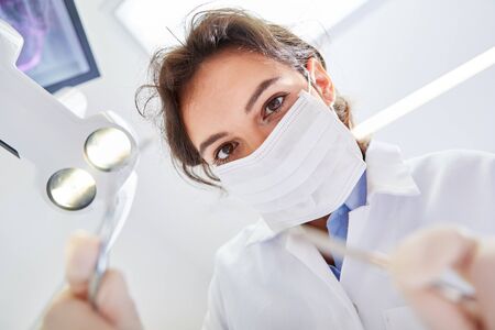 Young woman wearing surgical mask as a dentist or dental assistant in trainingの写真素材
