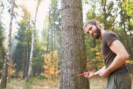 Forester with growth drill tests tree health and measures the wood growthの写真素材
