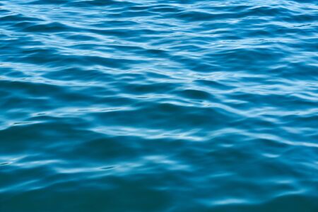 Blue water surface from the sea or ocean with light waves