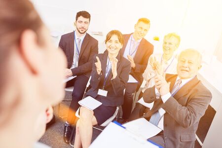 Business people as audience clap hands after business workshop