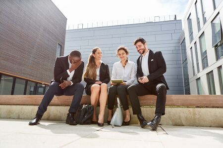 Happy business team in a break in front of the office or group in summerの写真素材