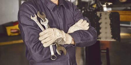 Mechatronics engineer with tool in his hand in a car workshopの写真素材