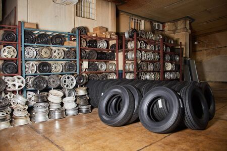 Workshop stock with selection of car tires and rimsの写真素材