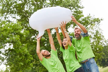 Three young people in an environmental action with a white balloon